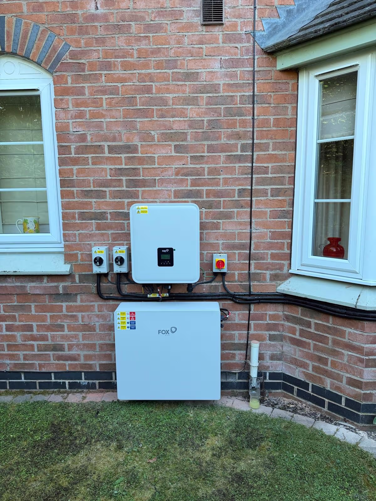 Fox ESS inverter and battery storage beside a bay window